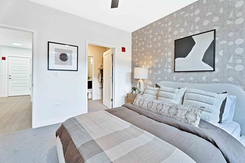 A bedroom with a large bed and a painting on the wall.