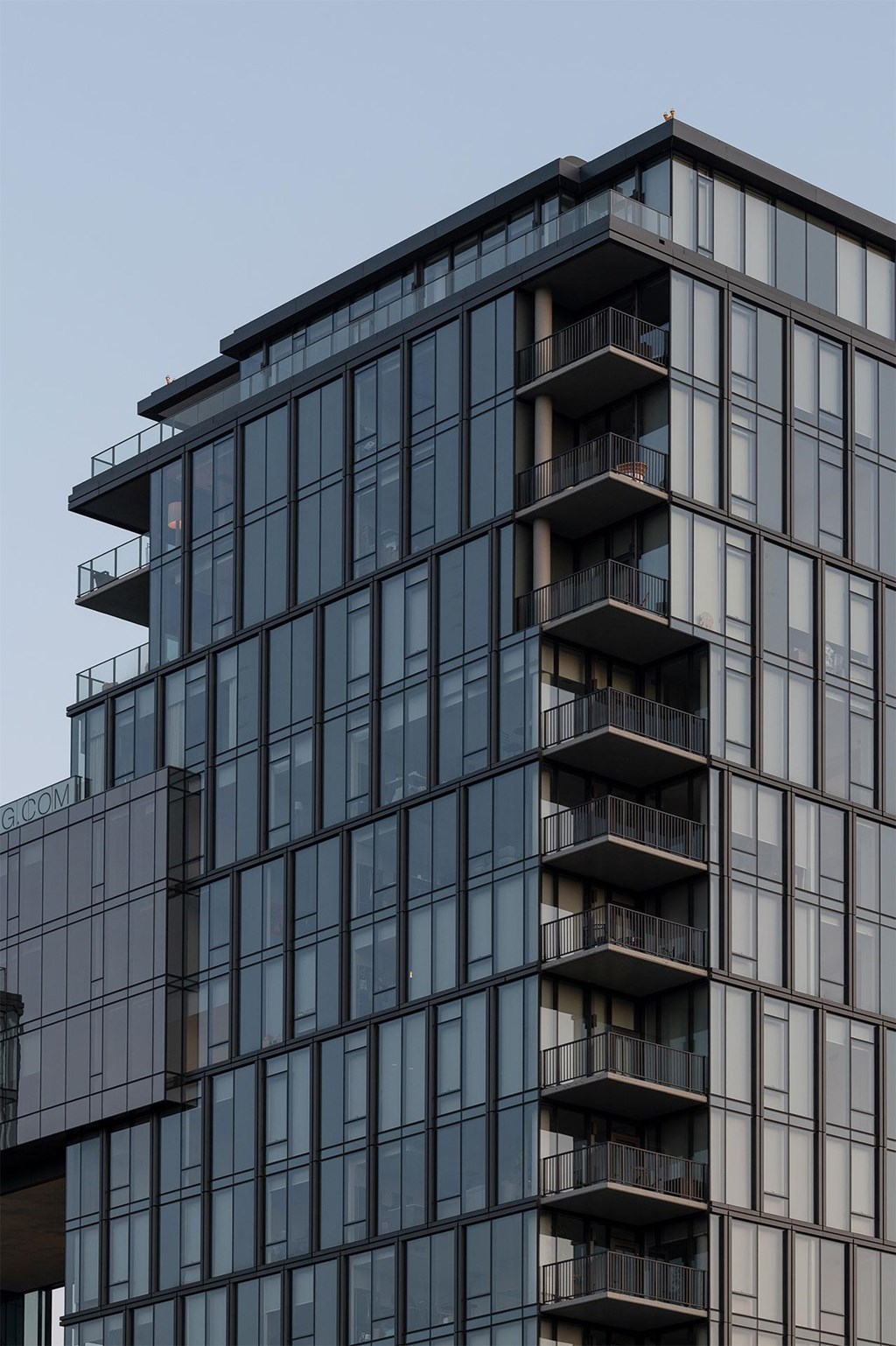 A tall building with balconies on each floor.