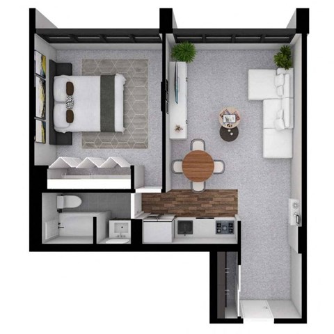 A small room with a bed, a table, and a microwave.