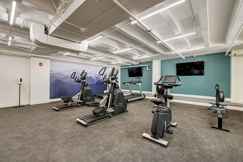 a gym with treadmills and other exercise equipment