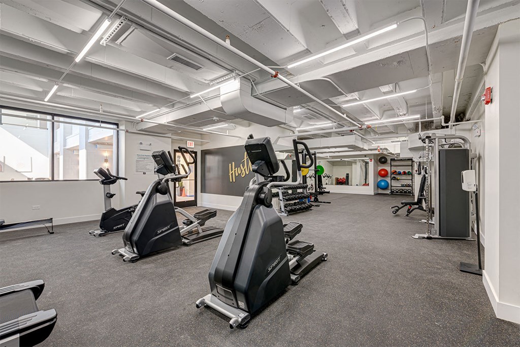 a gym with treadmills and other exercise equipment in a building