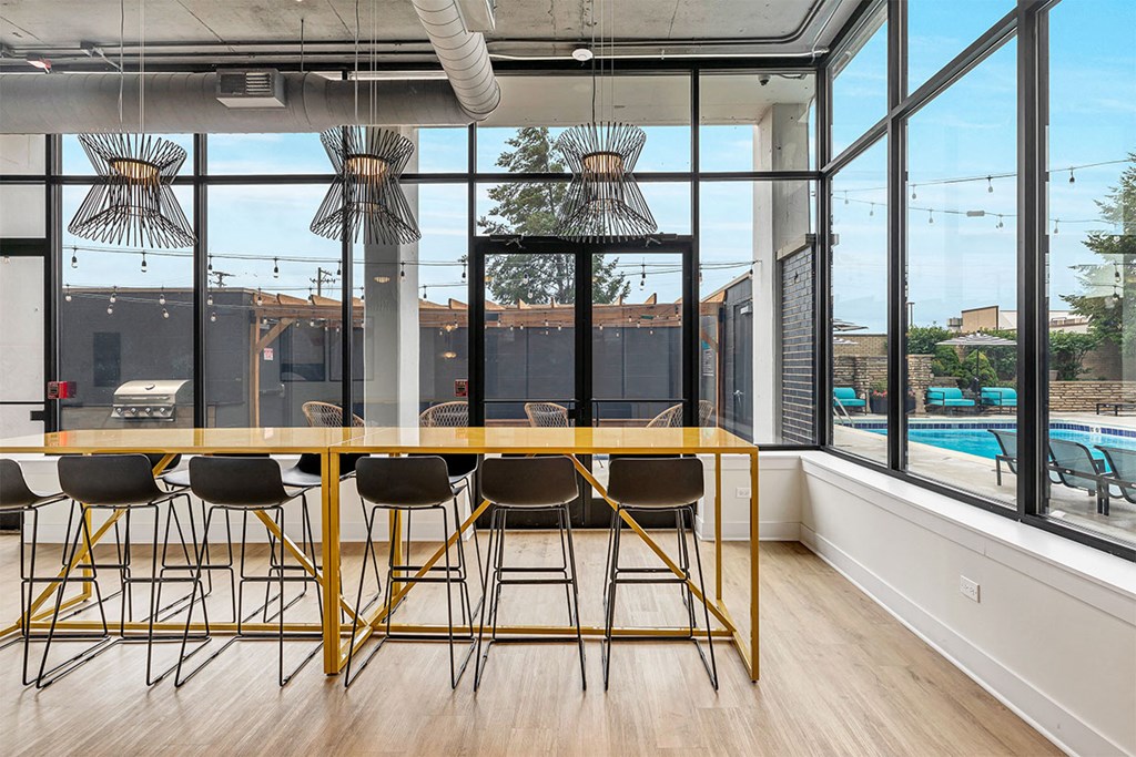 a dining room with a large window and a table with chairs