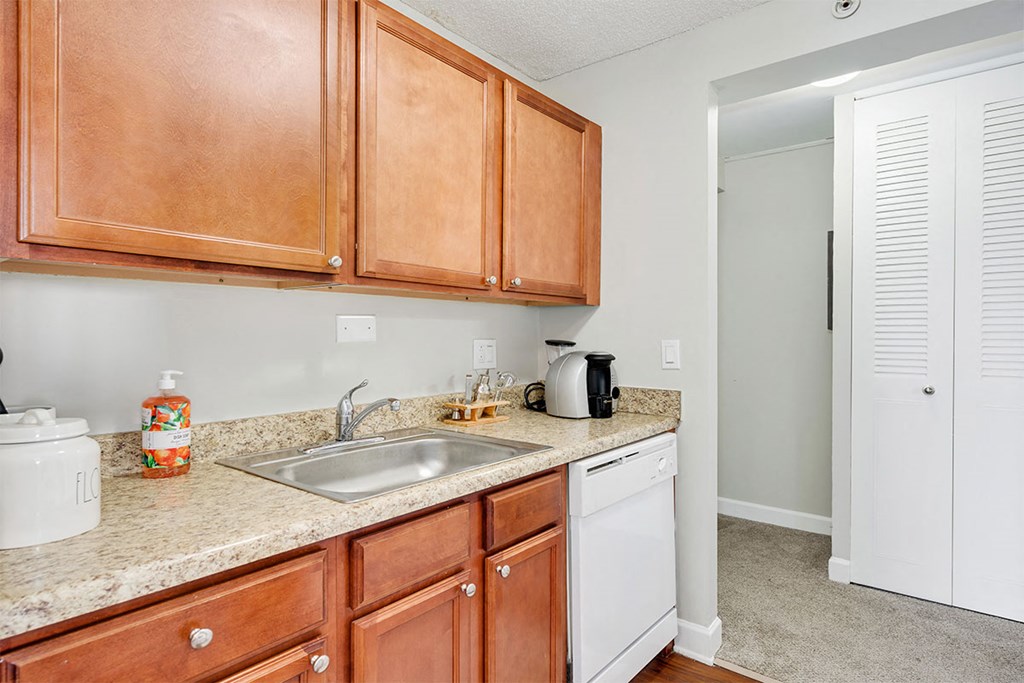 a kitchen with wooden cabinets and a sink