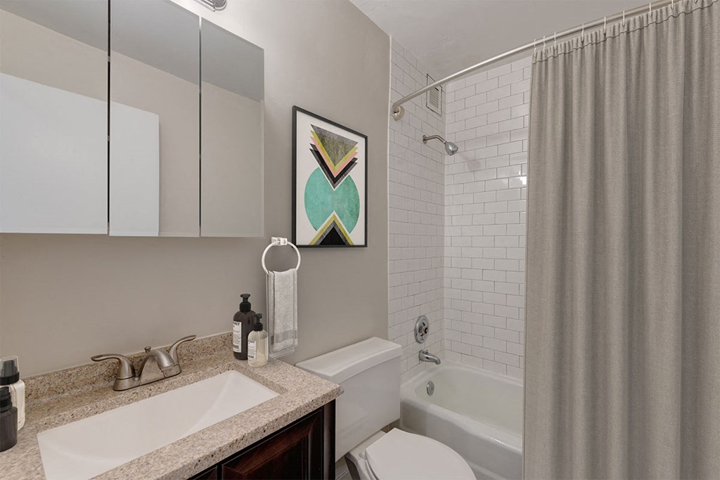 a bathroom with a shower and a sink and a toilet