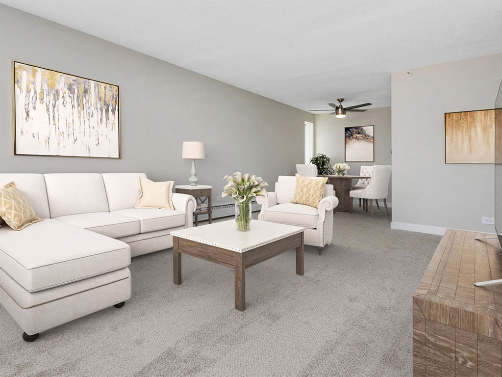 a living room with white couches and a coffee table