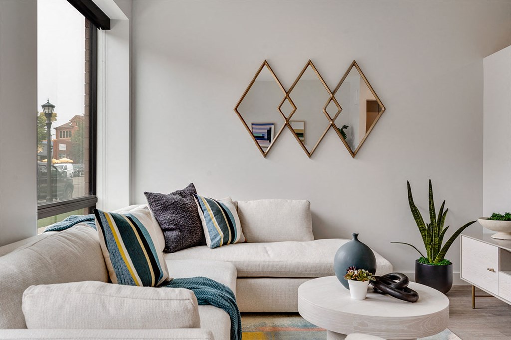 A living room with a white couch and a coffee table.