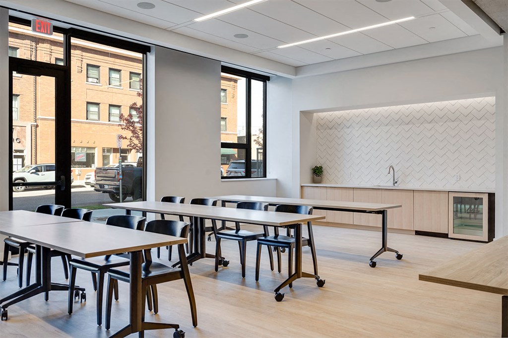 A conference room with a long table and chairs.