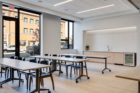 A conference room with a long table and chairs.