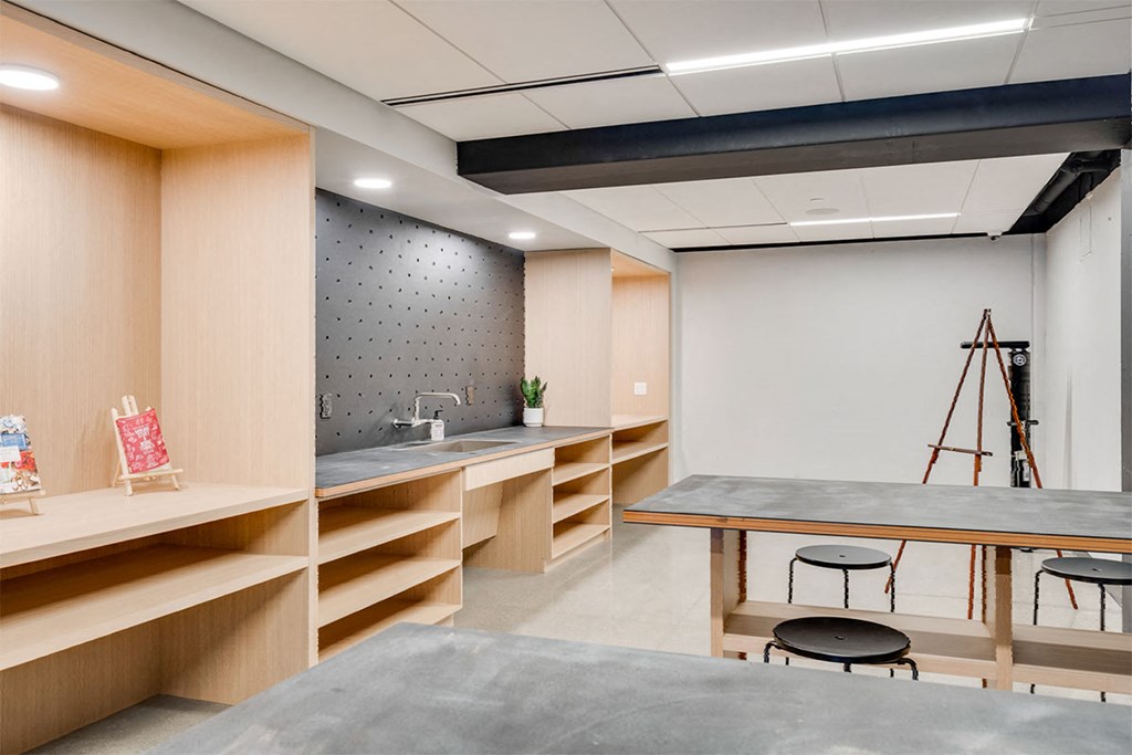 A modern kitchen with wooden cabinets and a grey countertop.