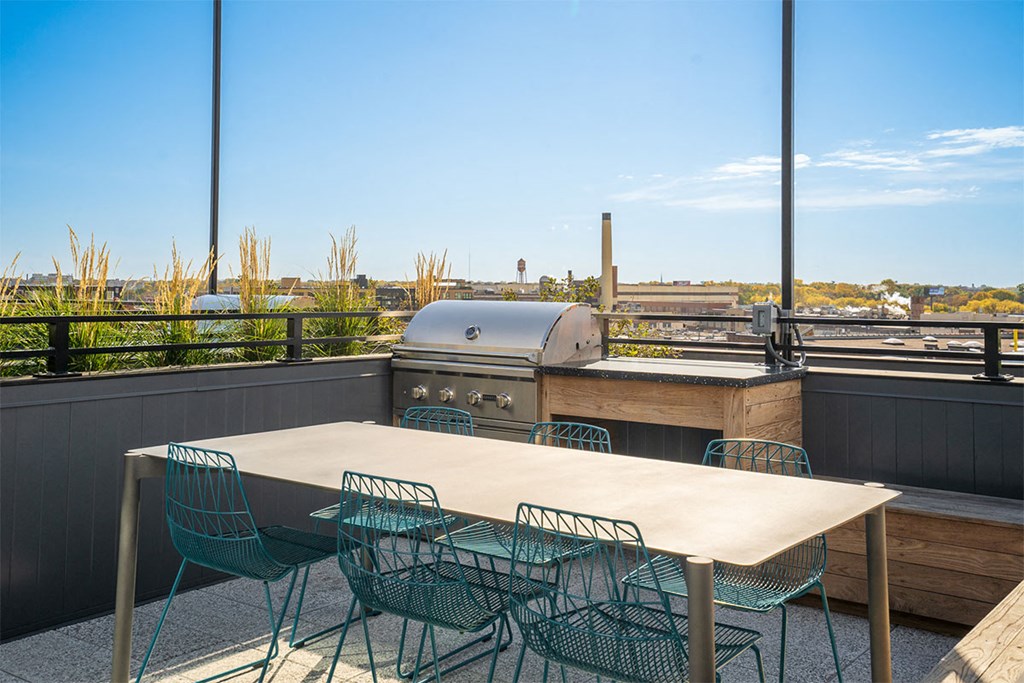 A table with chairs is set up on a balcony.
