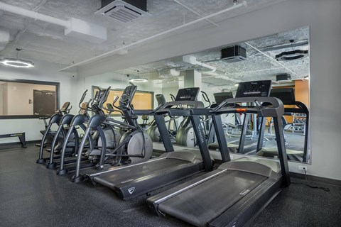 A gym with treadmills and exercise bikes.