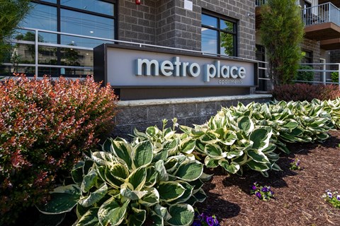 A building with a sign that says Metro Place in front of it.