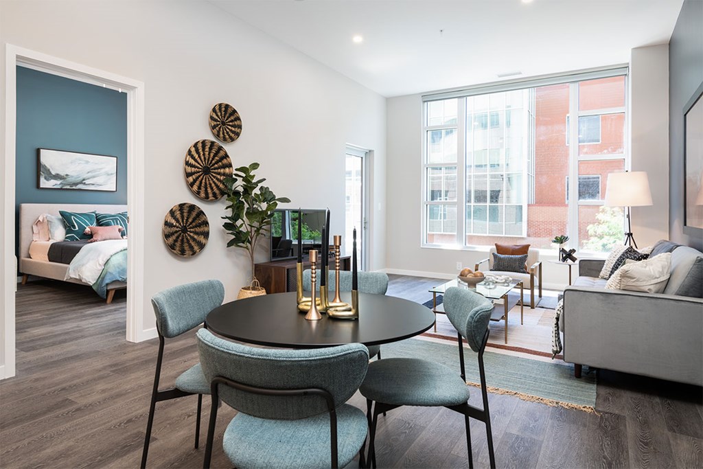 A modern living room with a round table and chairs.