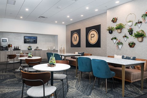A modern dining area with tables and chairs.