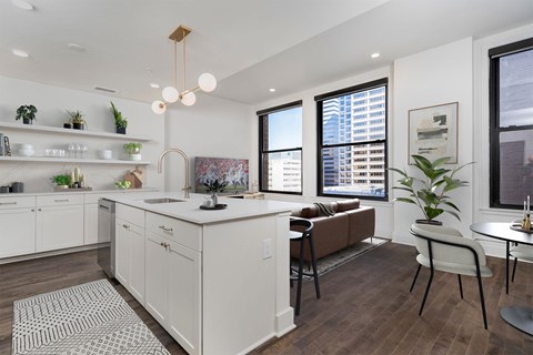 A modern kitchen with white cabinets and a brown countertop.