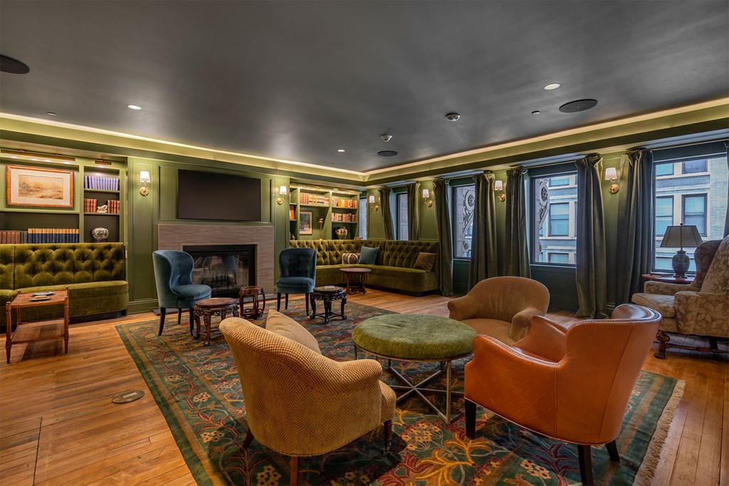 A living room with a fireplace and a green sofa.