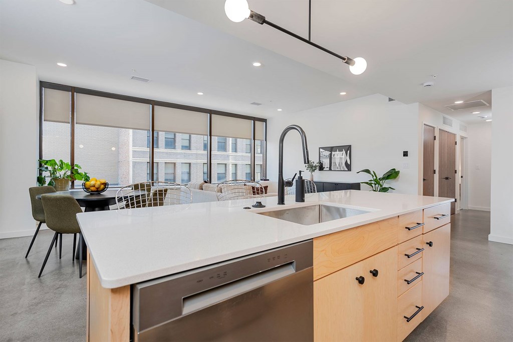 A modern kitchen with a large island and stainless steel appliances.