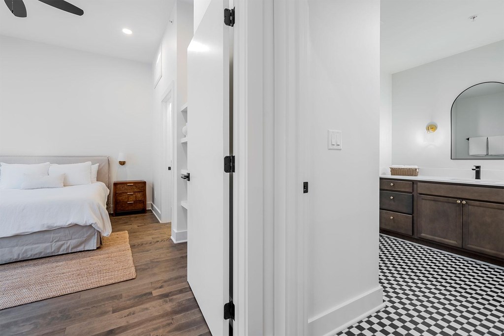 A white bedroom with a black and white checkered floor.