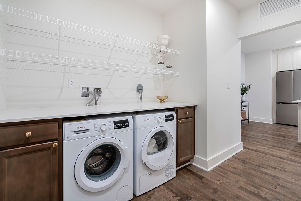A laundry room with two front loading washing machines.