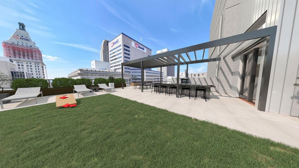 a roof top patio with a lawn and a table and chairs