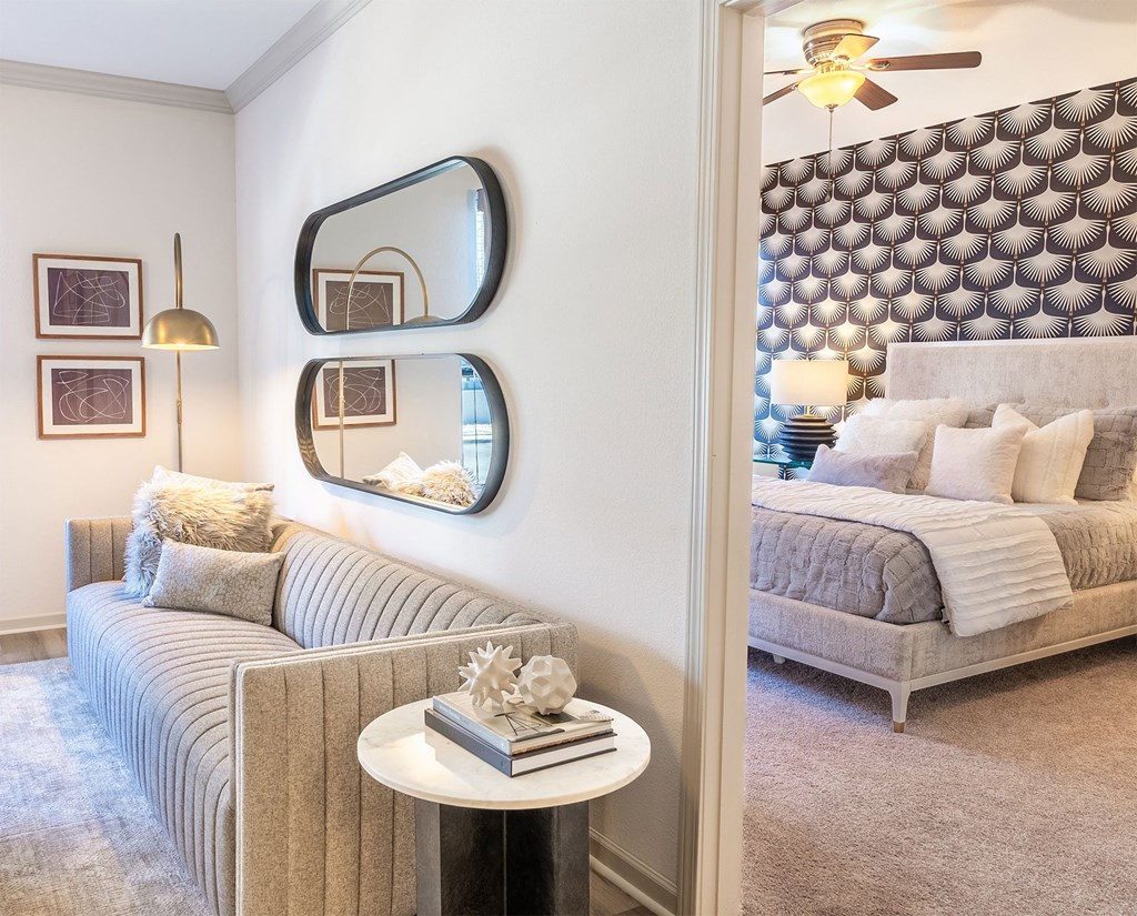 a living room with a couch and a bedroom