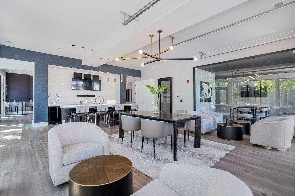 a living room and dining room with a table and chairs