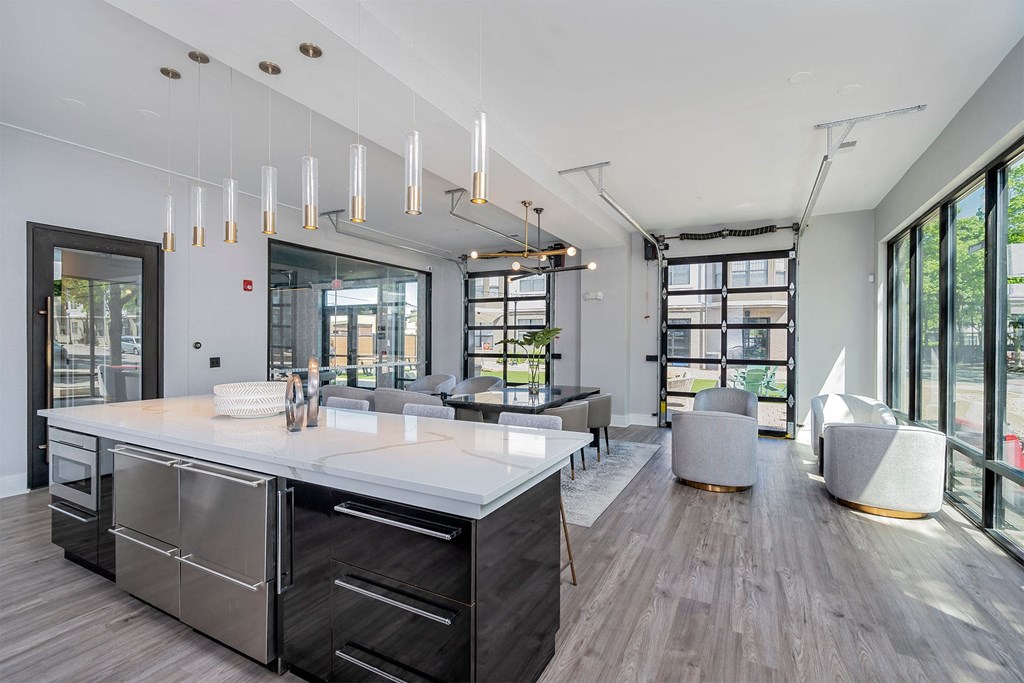 a kitchen with a large island and a living room with couches