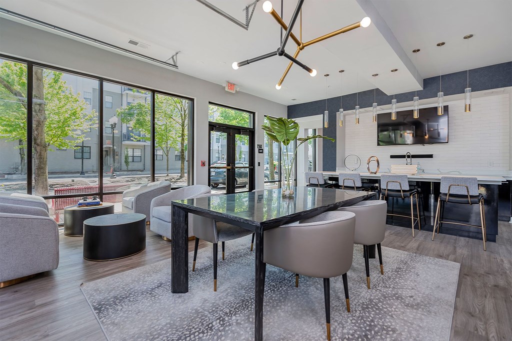 a dining room and living room with a glass table and chairs