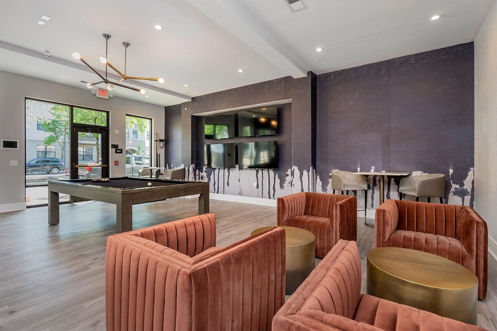 a clubhouse with a pool table and chairs