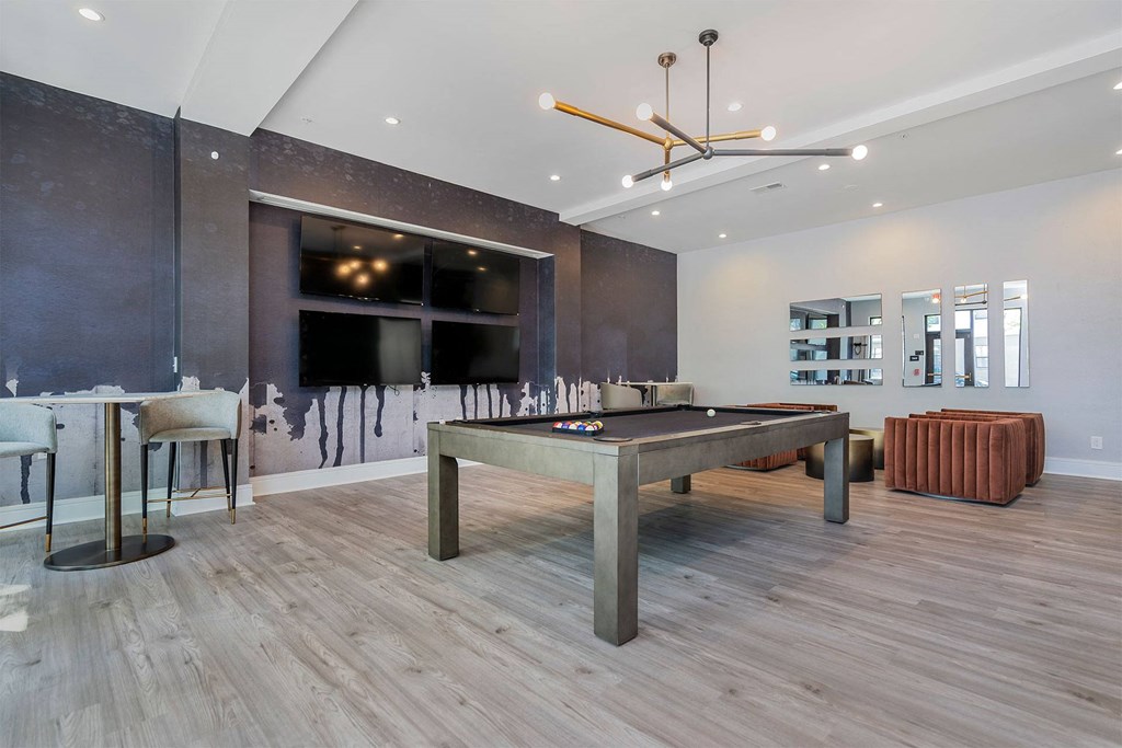 a games room with a pool table and a bar