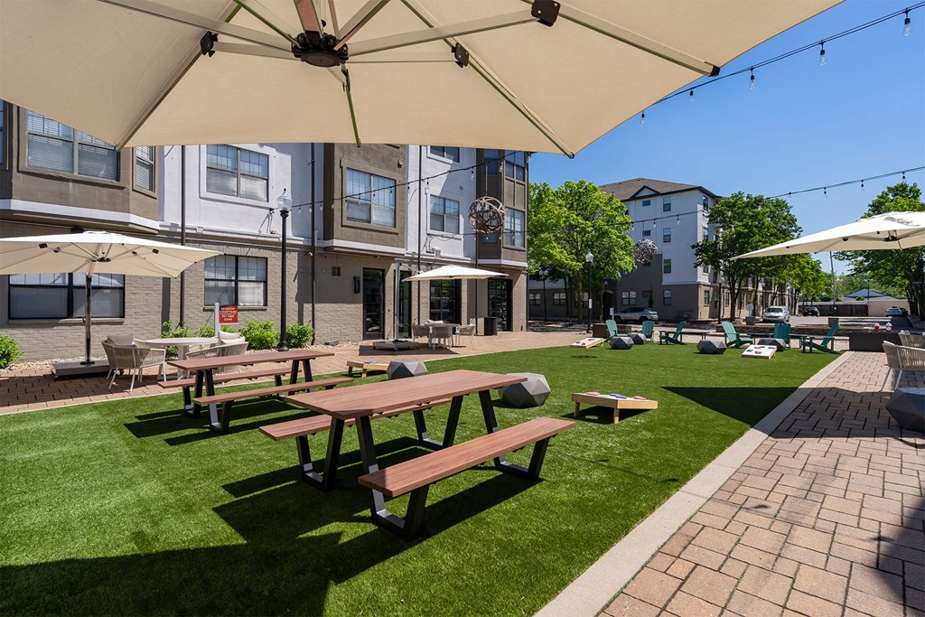 a patio with picnic tables and umbrellas