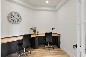 an office with a desk and a clock on the wall