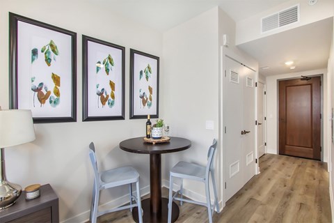 A dining area with a table and chairs.