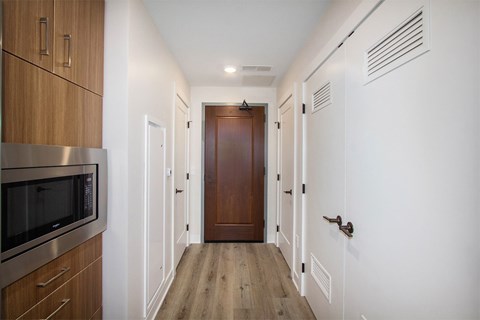 A long hallway with a door at the end.