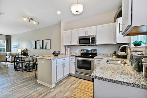 a kitchen with granite counter tops and stainless steel appliances