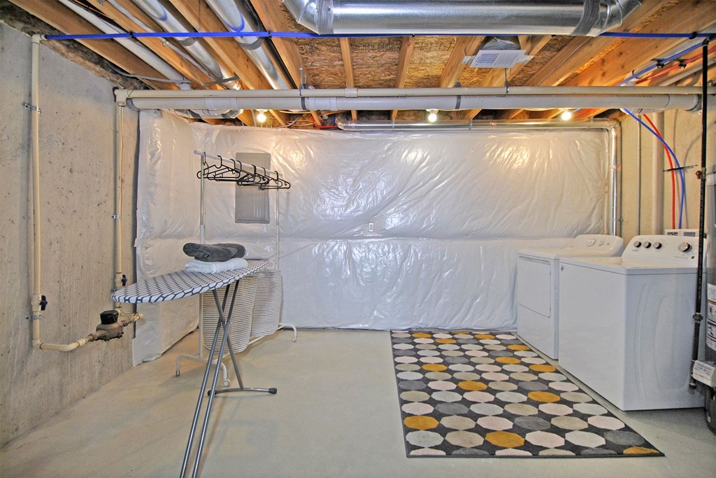 a room with a dryer and a wall covered in plastic