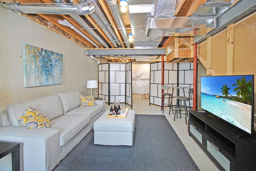 a living room with a white couch and a tv