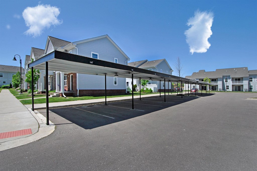 an empty parking lot in front of a row of houses