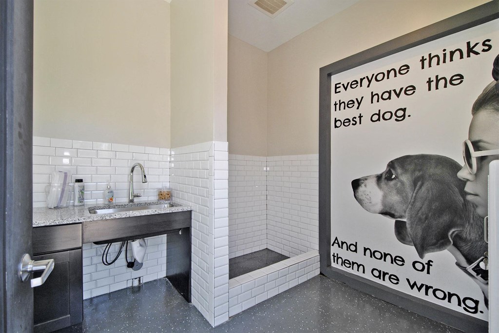 a dog in a bathroom with a sign that says everyone thinks they have the best