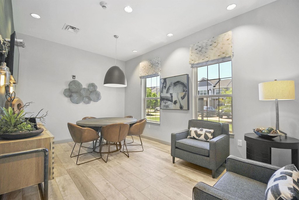 a dining room and living room with a table and chairs