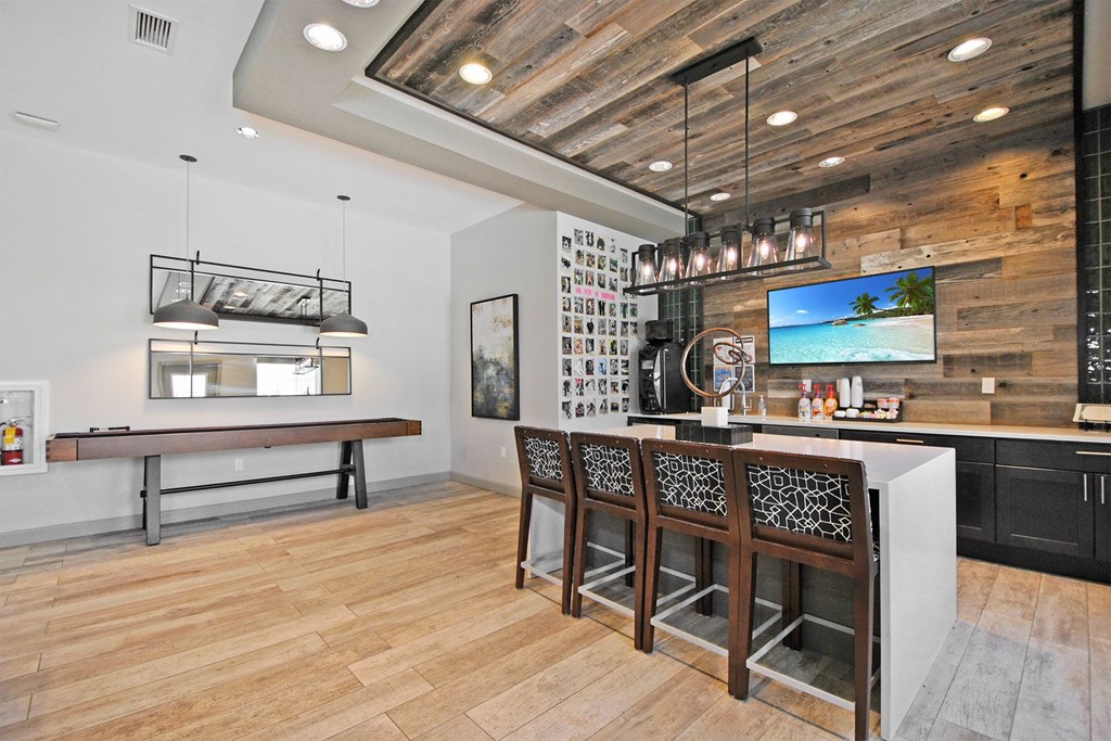 a kitchen with a bar and a table with chairs