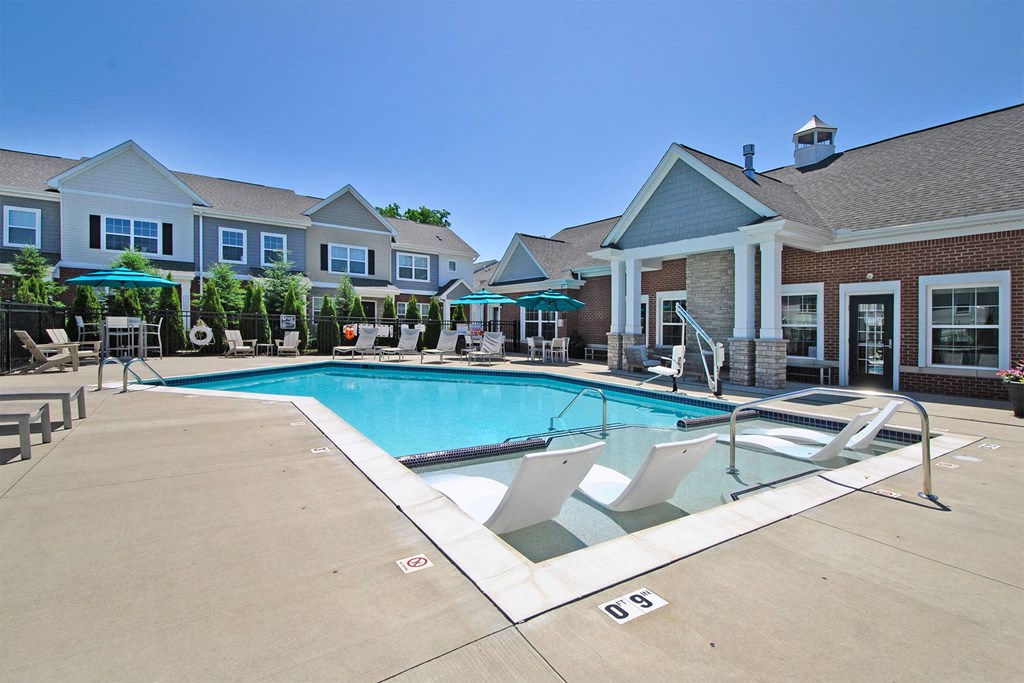 our apartments have a swimming pool with chairs and umbrellas