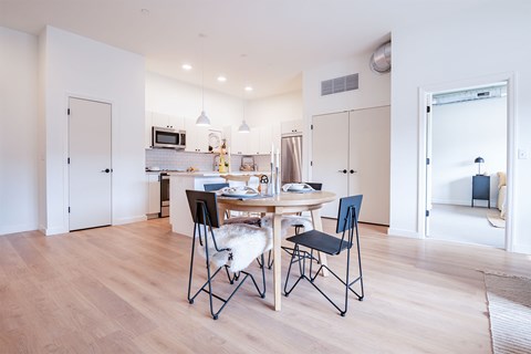 A dining room with a table and chairs.