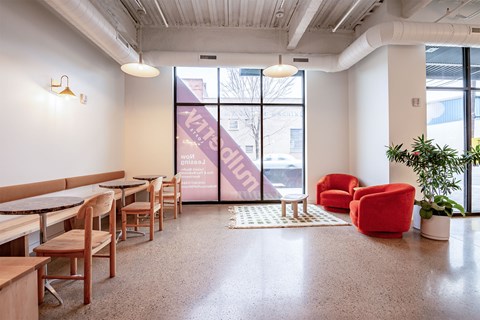 A room with a white wall and a purple banner on the window.