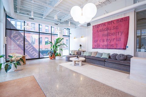 A brightly lit office space with a large banner on the wall.