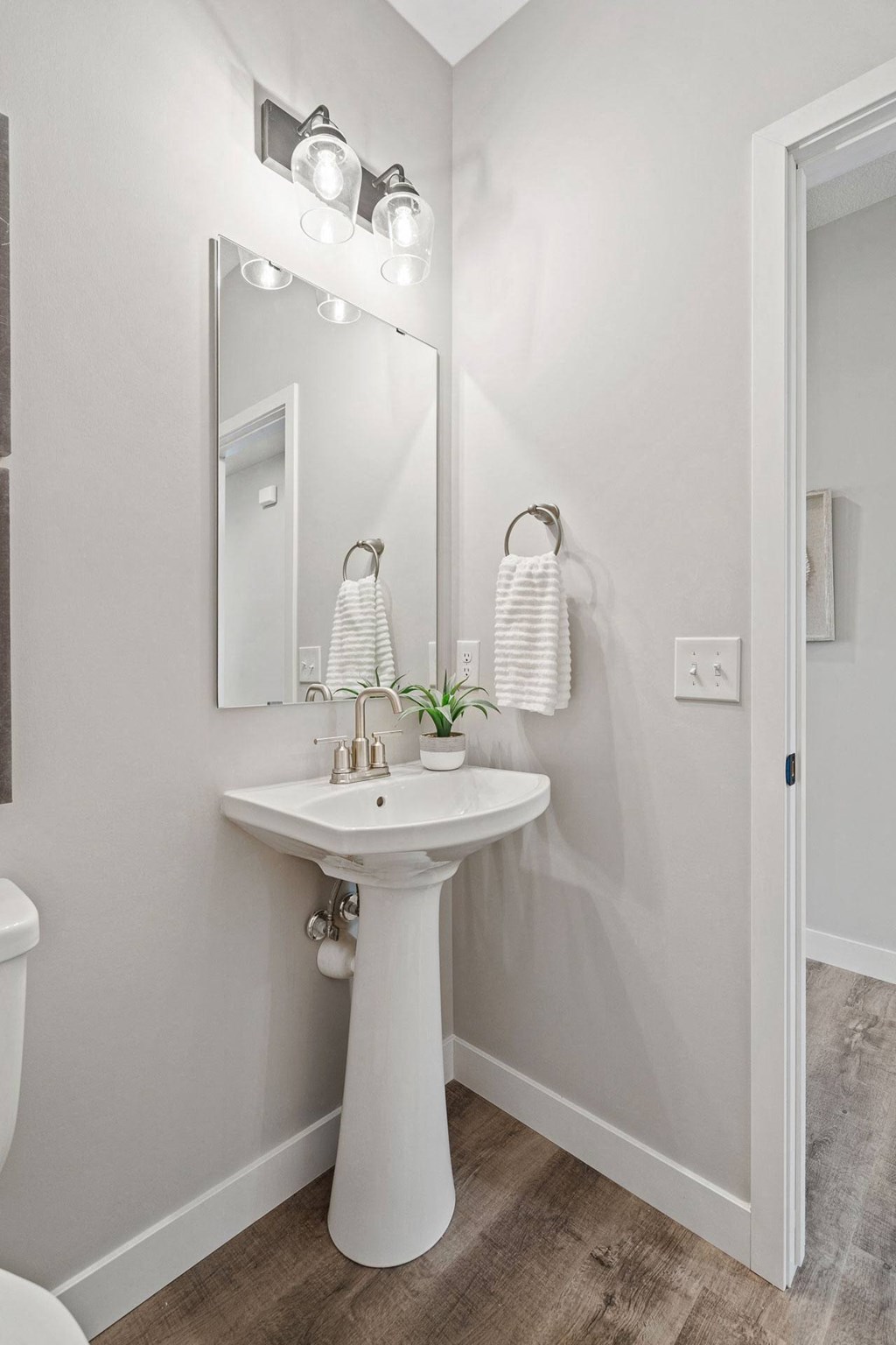 a white bathroom with a sink and a mirror