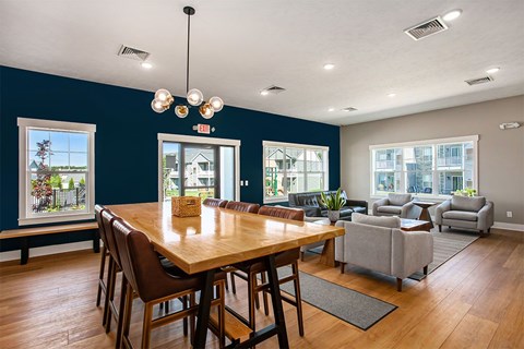 A dining room with a wooden table and chairs.