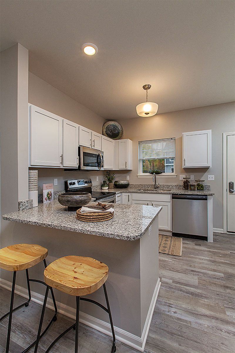 Midtown Pointe Kitchen With Peninsula and White Cabinets