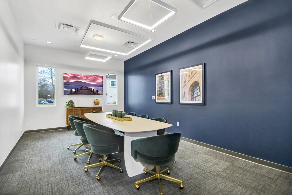 a conference room with blue walls and a white table and chairs