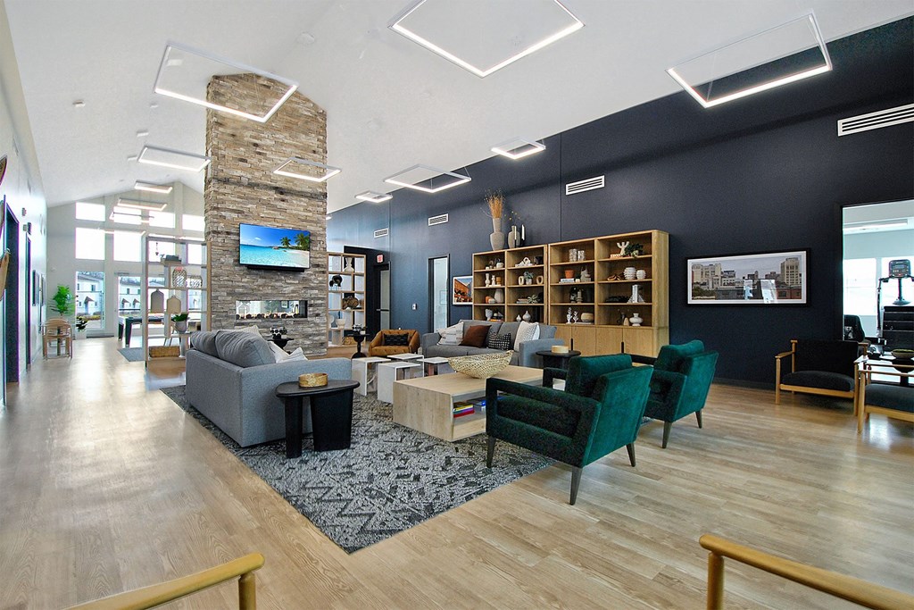 a living room with couches and chairs and a fireplace